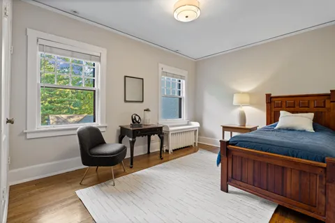 a bedroom with furniture and a window