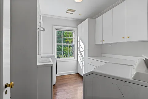 a view of washer and dryer with kitchen in the background