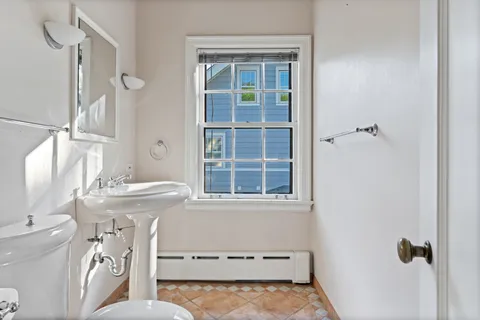 a bathroom with a sink a toilet and a shower
