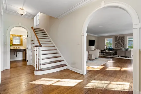 a view of a livingroom with wooden floor and furniture