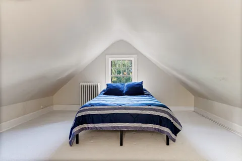 a bedroom with a bed and window
