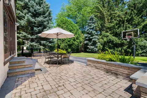 a view of backyard with seating space and trees