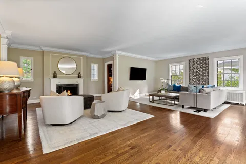 a living room with fireplace furniture and a wooden floor
