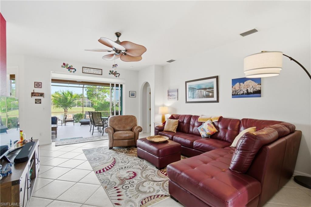 3948 Ruxton Road Naples, FL 34116 - Photo 11 of 43 a living room with furniture and a large window