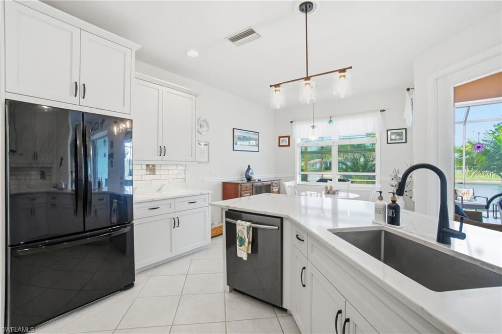 3948 Ruxton Road Naples, FL 34116 - Photo 14 of 43 a kitchen with a sink appliances and cabinets