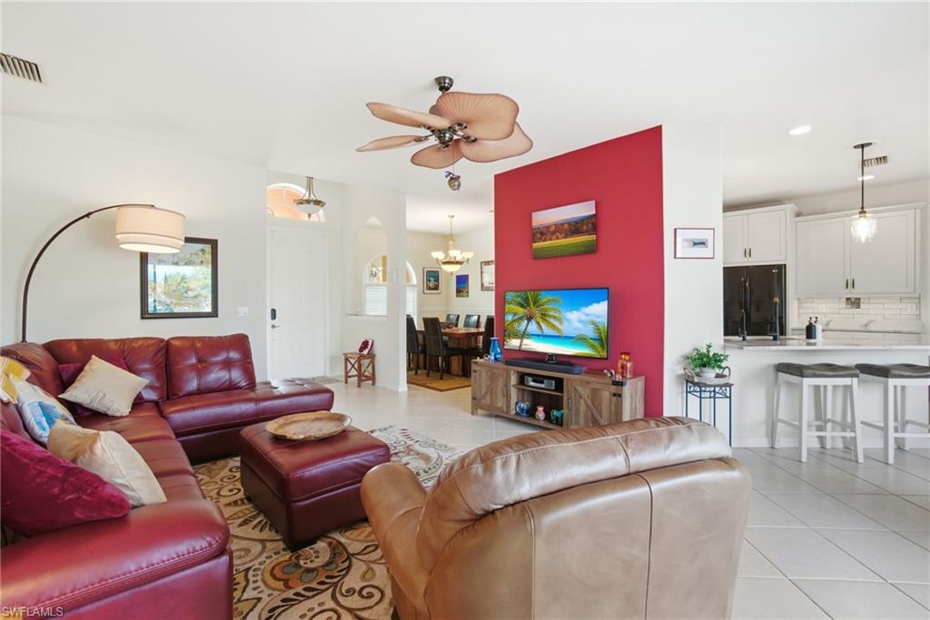 3948 Ruxton Road Naples, FL 34116 - Photo 16 of 43 a living room with furniture a flat screen tv and kitchen view