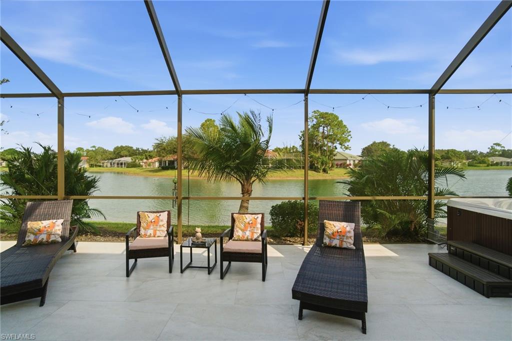 3948 Ruxton Road Naples, FL 34116 - Photo 2 of 43 a sitting area with glass top table and chairs