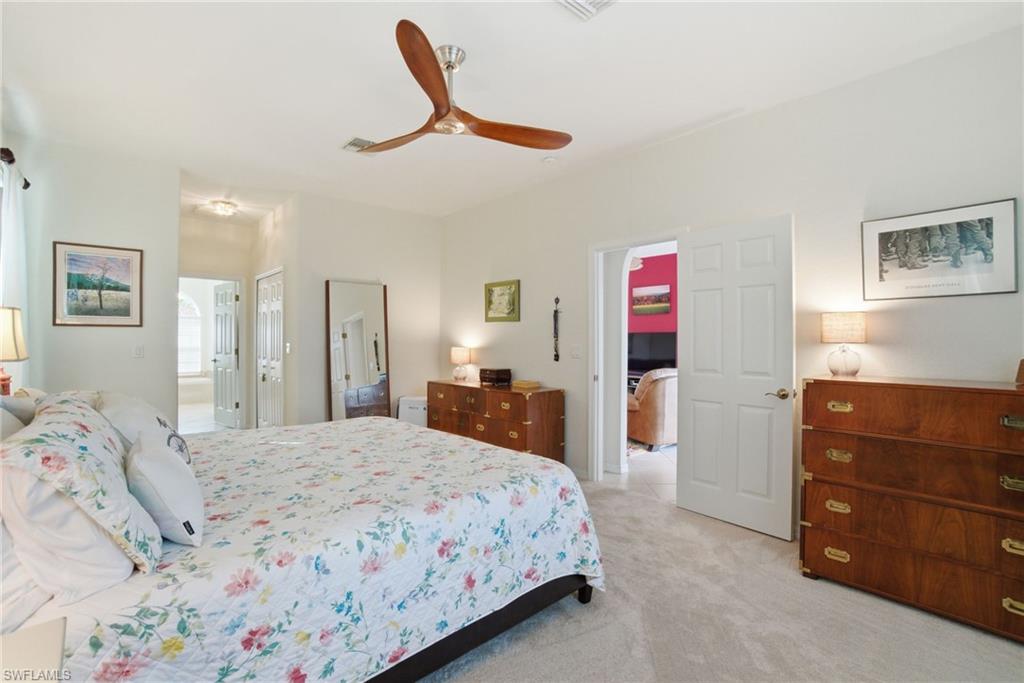3948 Ruxton Road Naples, FL 34116 - Photo 23 of 43 a bedroom with a bed and a dresser