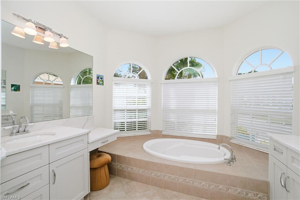 3948 Ruxton Road Naples, FL 34116 - Photo 24 of 43 a bathroom with a granite countertop sink and a large mirror