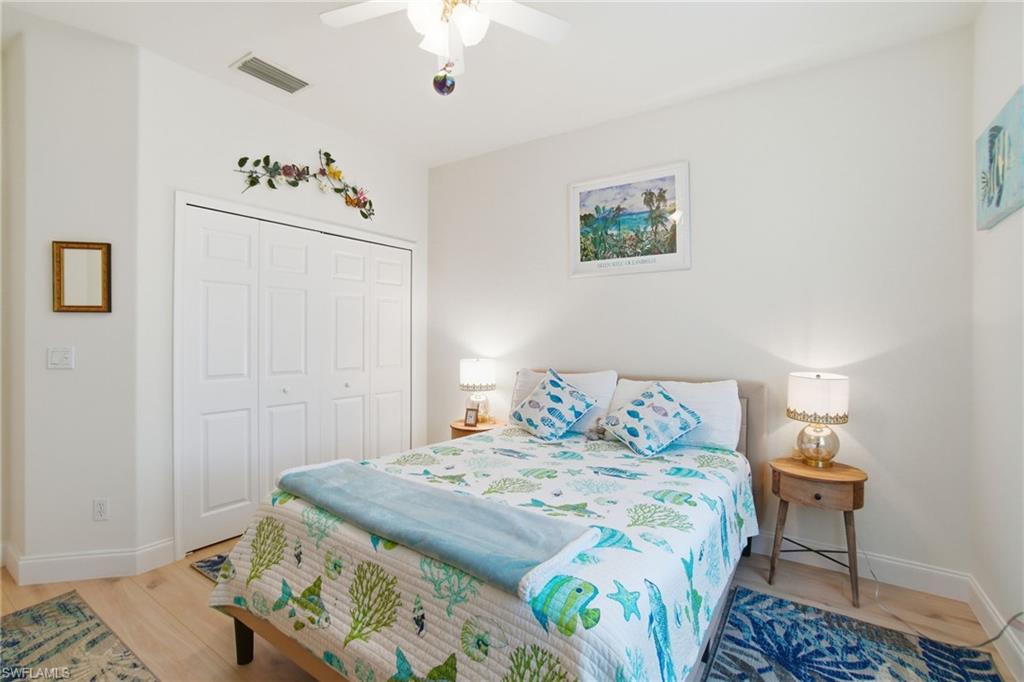 3948 Ruxton Road Naples, FL 34116 - Photo 29 of 43 a bedroom with a bed and a table in it