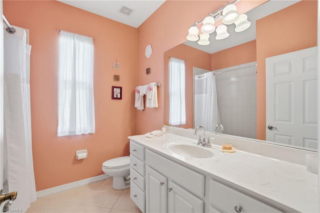 3948 Ruxton Road Naples, FL 34116 - Photo 30 of 43 a bathroom with a sink a toilet and a mirror