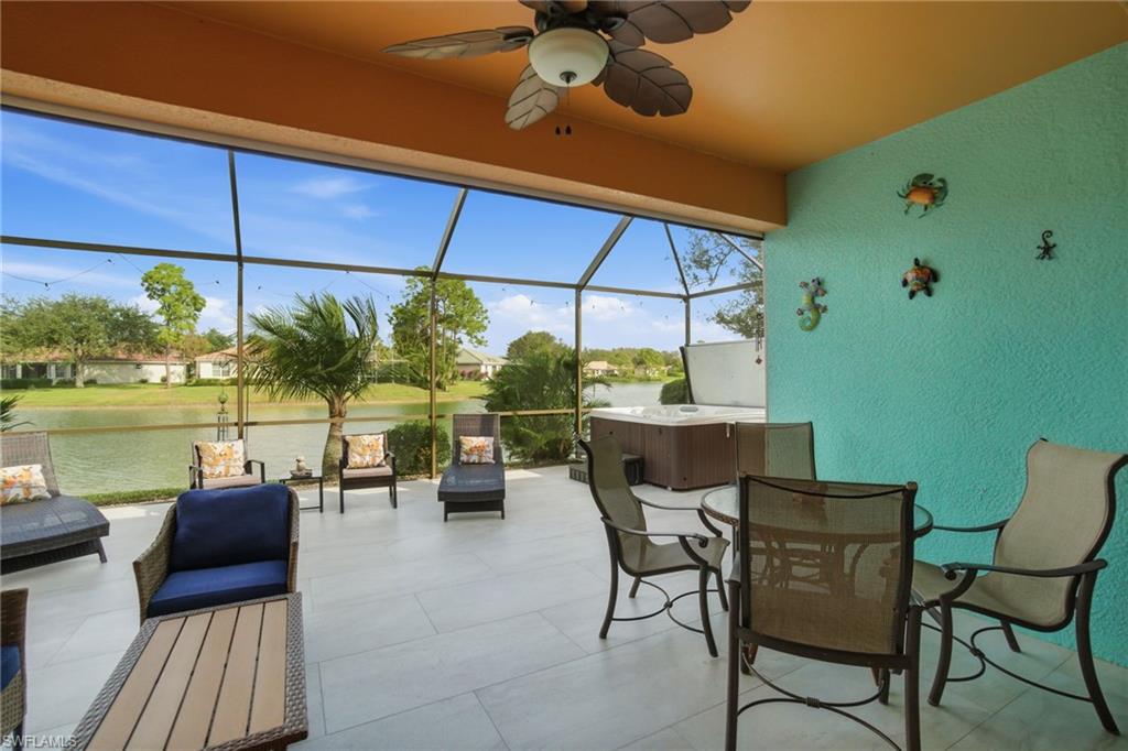 3948 Ruxton Road Naples, FL 34116 - Photo 36 of 43 a view of a patio with table and chairs under an umbrella