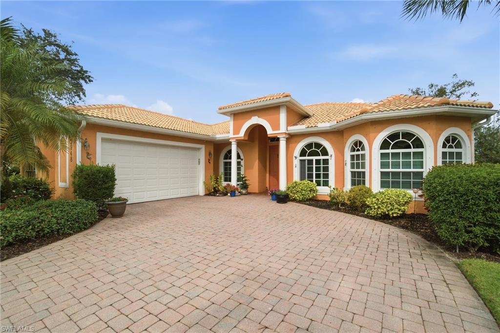 3948 Ruxton Road Naples, FL 34116 - Photo 39 of 43 a front view of a house with a yard and garage