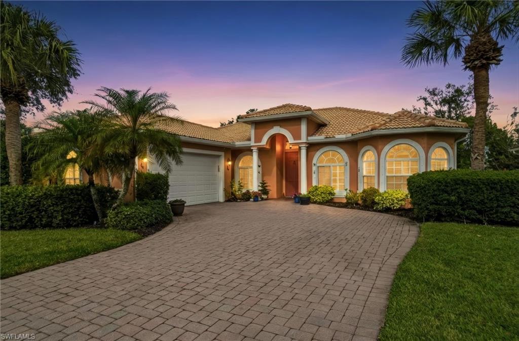 3948 Ruxton Road Naples, FL 34116 - Photo 40 of 43 a front view of a house with a garden