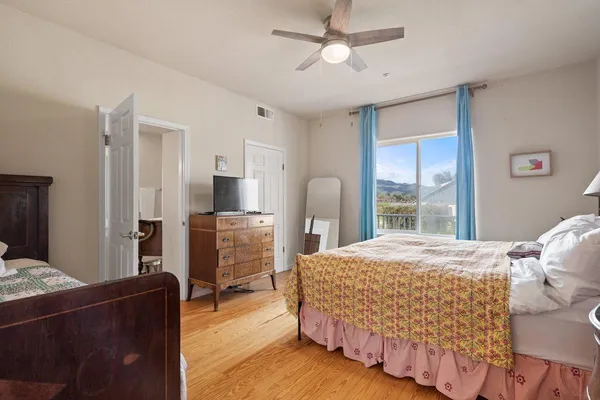 a bedroom with a bed and ceiling fan