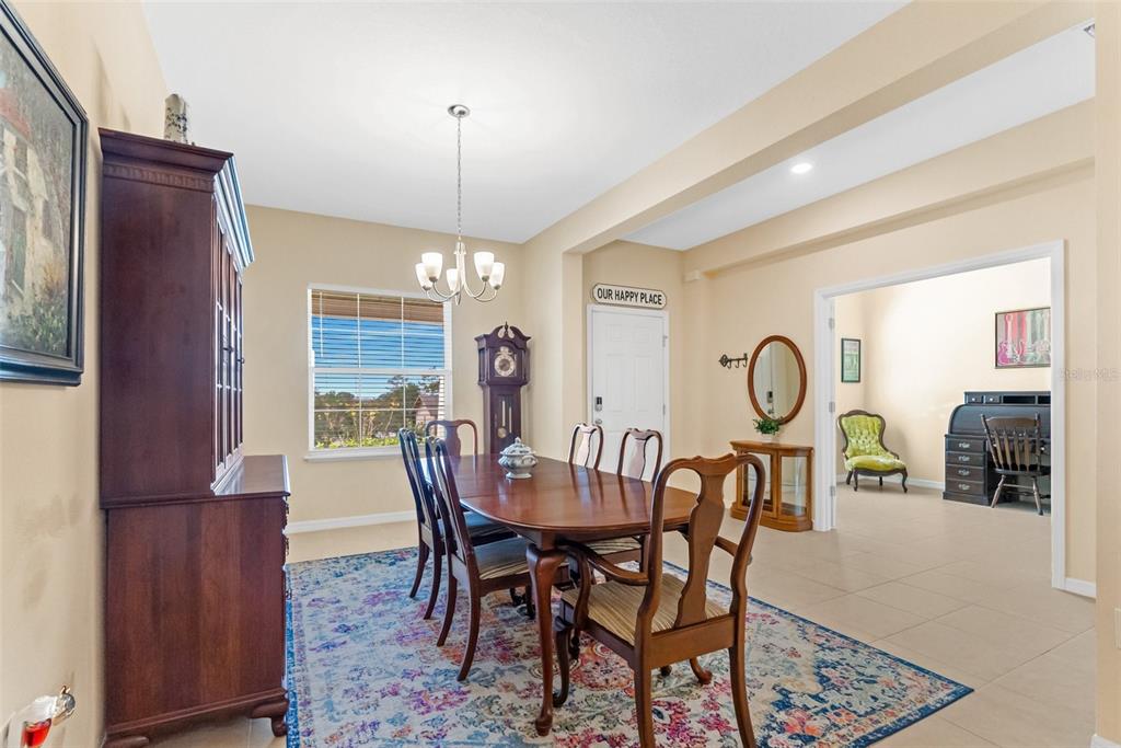 6283 Grapewood Road Spring Hill, FL 34609 - Photo 9 of 41 a view of a dining room and livingroom with furniture window and wooden floor