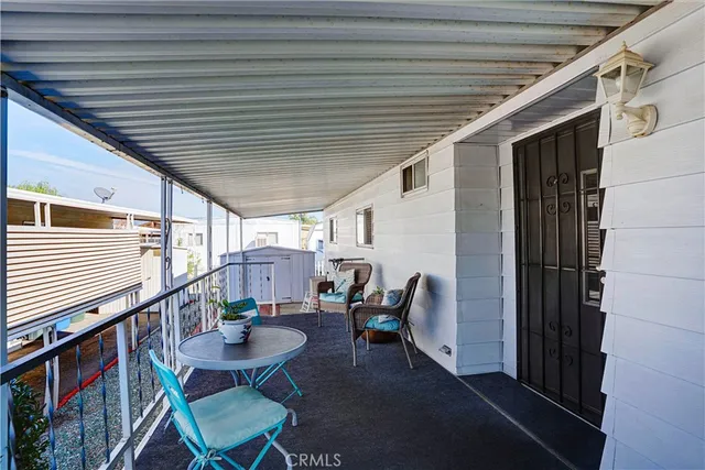 a balcony with chairs and table