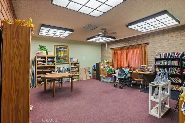 a view of a livingroom with furniture and a window