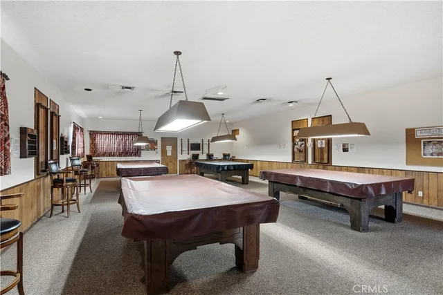 a living room with furniture a dining table and a chandelier