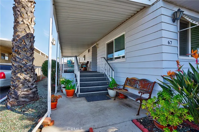a backyard of a house with outdoor seating and stairs