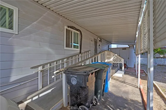 a view of a patio with table and chairs with an umbrella