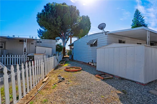a view of a house with wooden fence