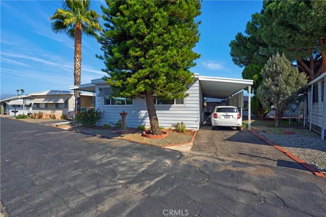 a view of a house with backyard and sitting area
