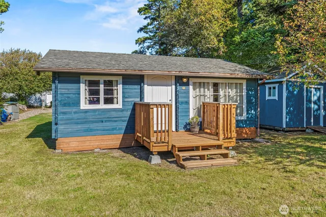 a backyard of a house with barbeque oven and wooden fence