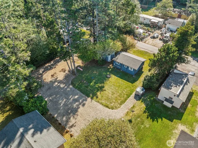 an aerial view of a house with a yard swimming pool and outdoor seating