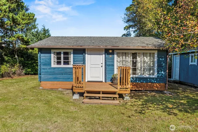 a backyard of a house with barbeque oven table and chairs