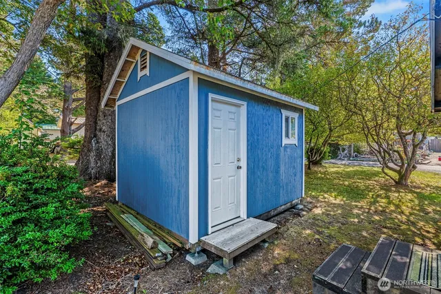 a backyard of a house with plants and tree
