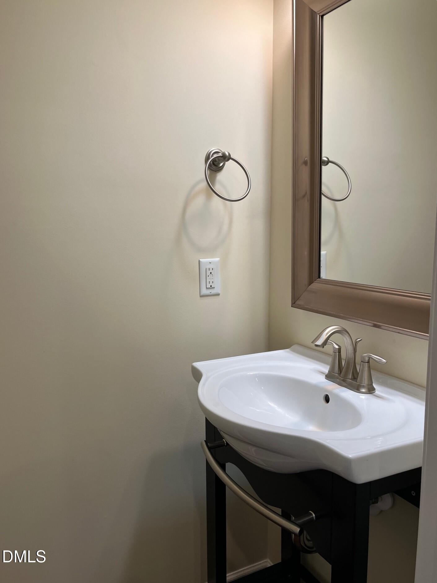 1517 Crafton Way Raleigh, NC 27607 - Photo 11 of 28 a bathroom with a sink and a mirror