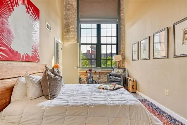 a bedroom with a bed and wooden floor