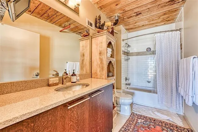 a bathroom with a double vanity sink toilet and shower