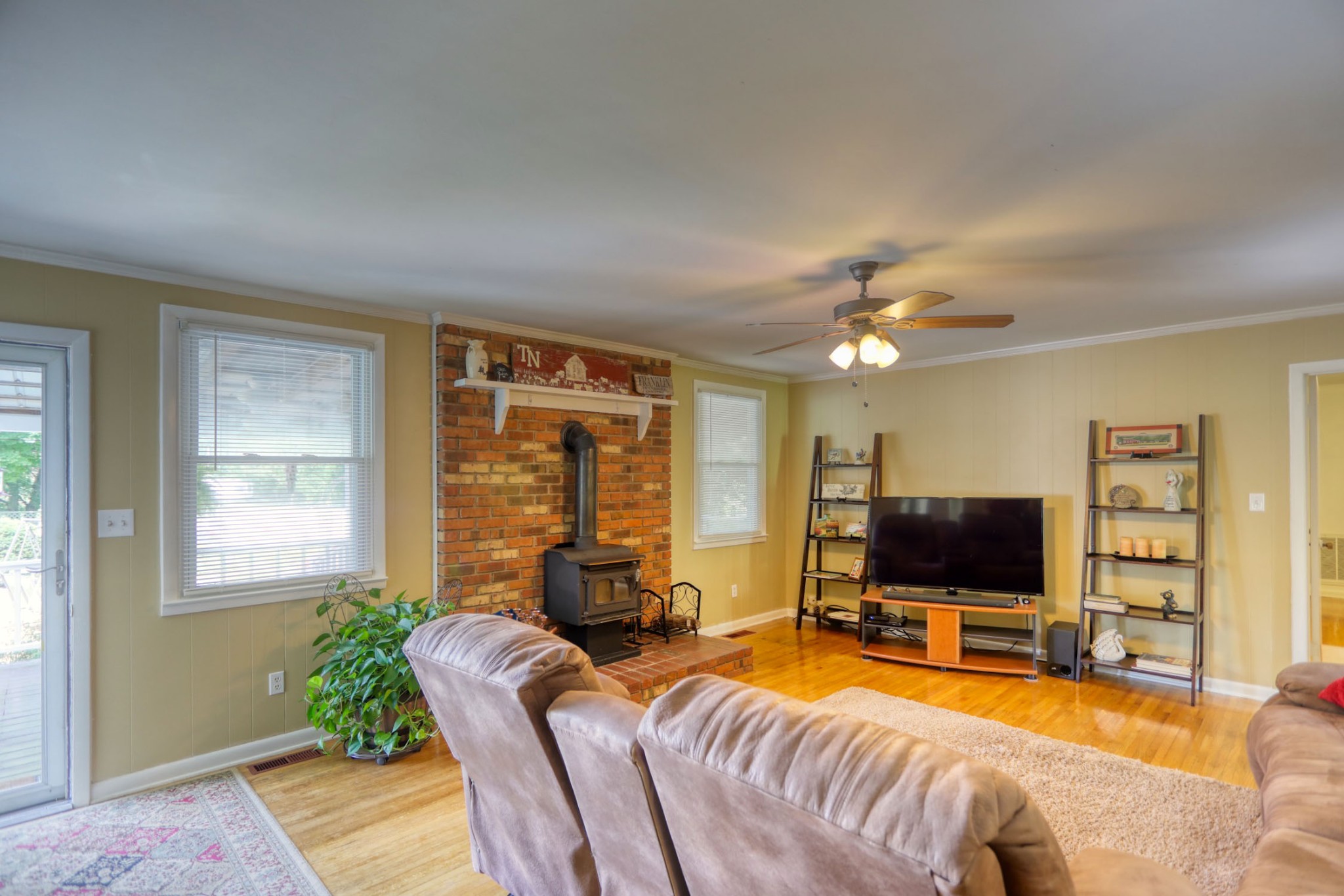 4644 East Robertson Road Cross Plains, TN 37049 - Photo 12 of 56 a living room with furniture a flat screen tv and large window