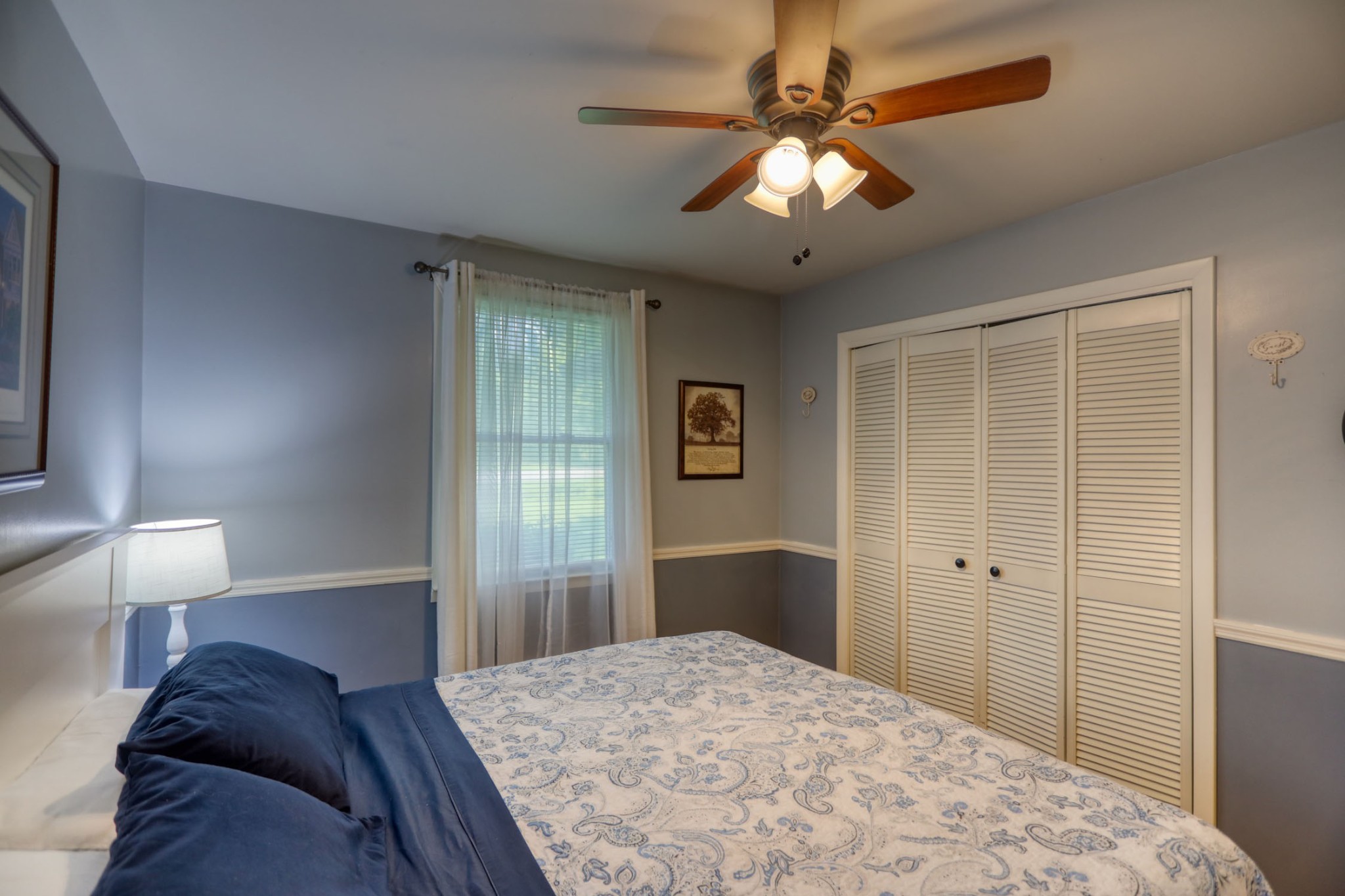 4644 East Robertson Road Cross Plains, TN 37049 - Photo 20 of 56 a bedroom with a large bed and a chandelier