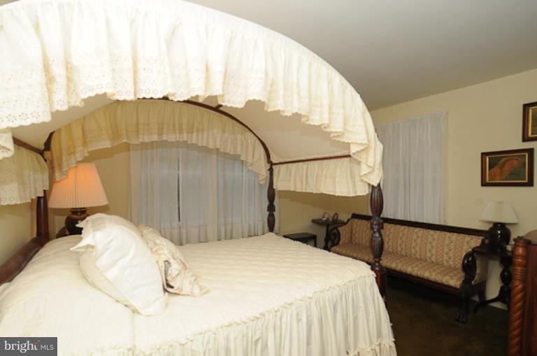 205 Providence Road Annapolis, MD 21409 - Photo 13 of 20 a bedroom with a bed and wooden floor
