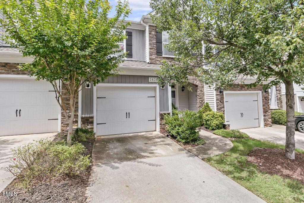2428 Memory Ridge Drive Raleigh, NC 27606 - Photo 1 of 36 a front view of a house with garden