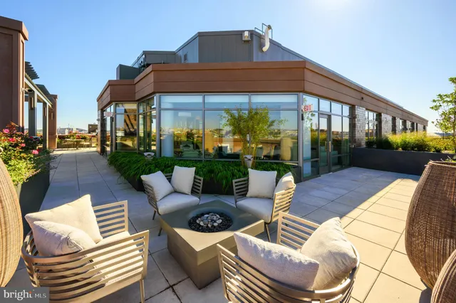 a view of a patio with couches table and chairs and potted plants