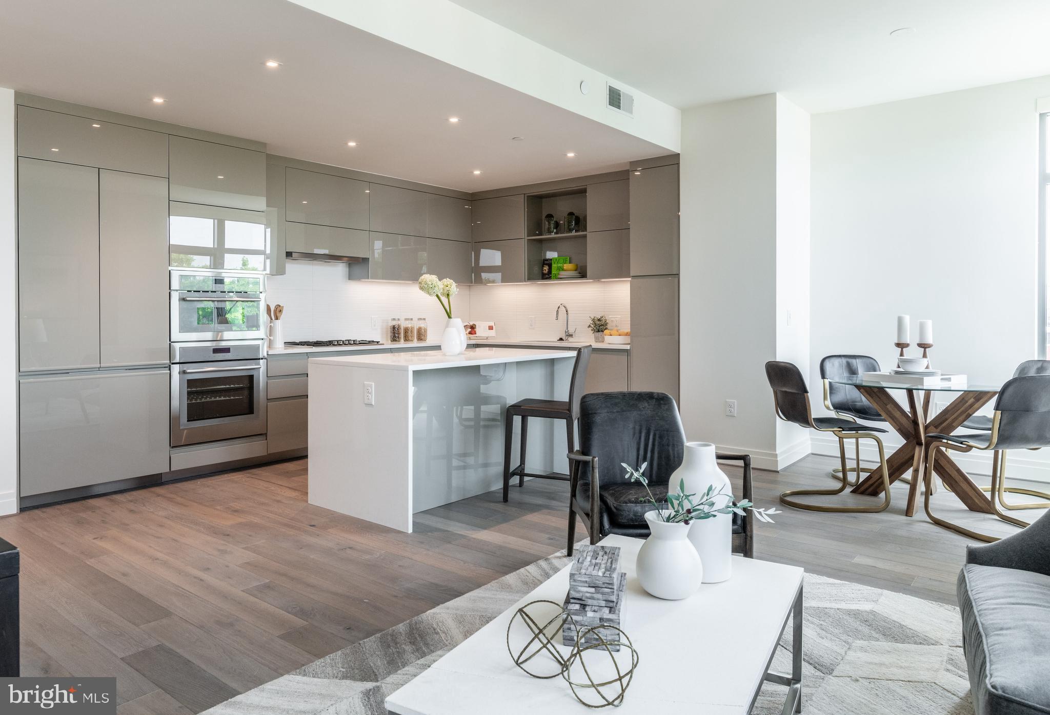 810 O Street Northwest, Unit 706 Washington, DC 20001 - Photo 17 of 48 a kitchen with stainless steel appliances granite countertop a table and chairs in it