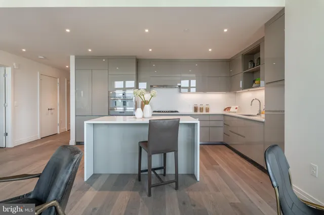 a kitchen with a sink cabinets and wooden floor