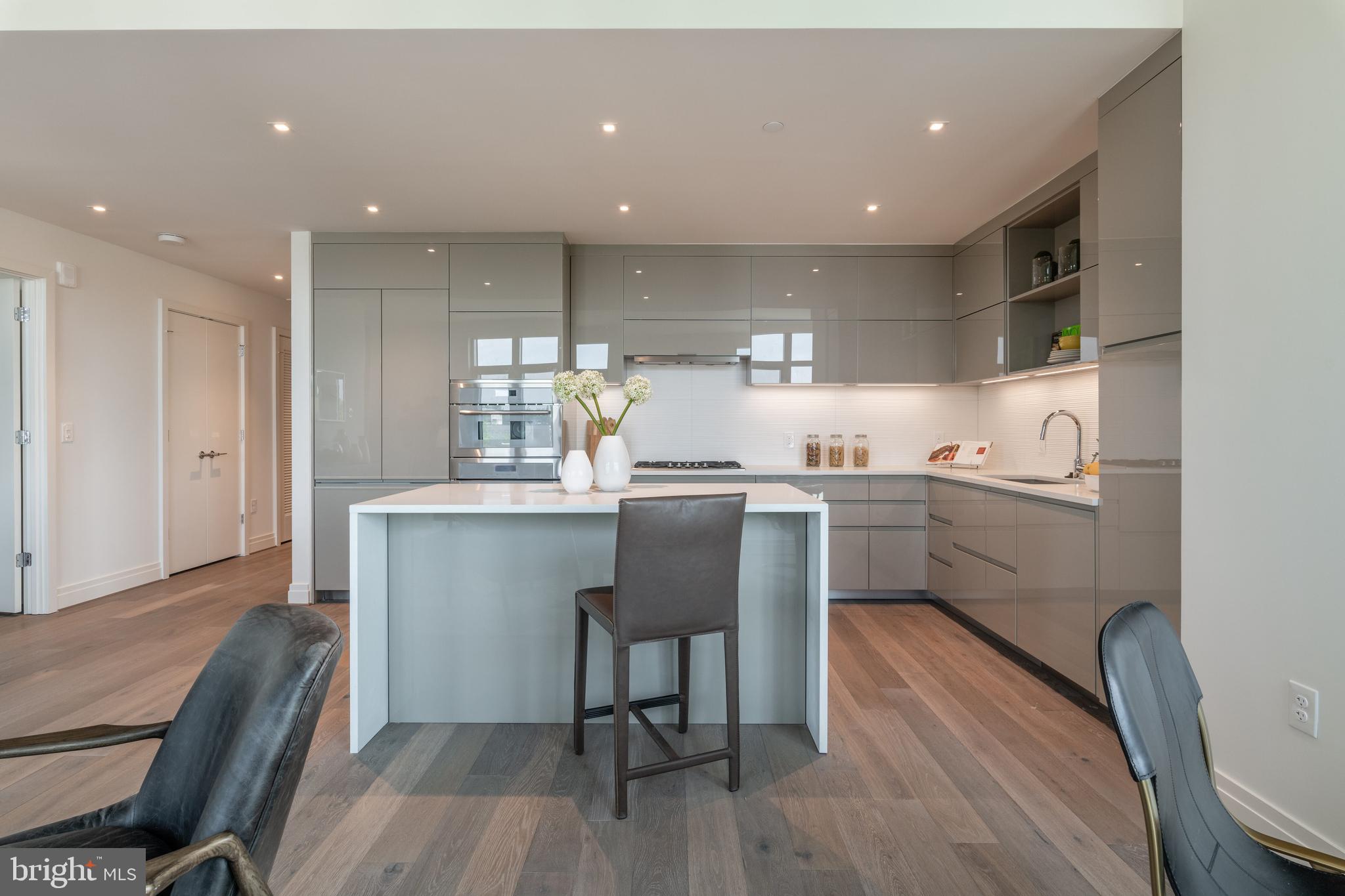 810 O Street Northwest, Unit 706 Washington, DC 20001 - Photo 18 of 48 a kitchen with a sink cabinets and wooden floor