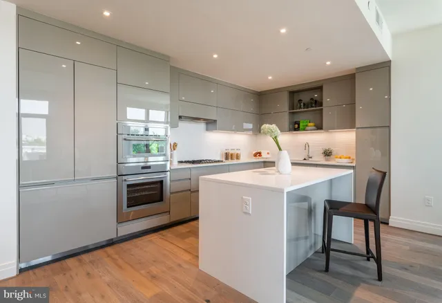 a kitchen with a sink a stove a refrigerator and a refrigerator