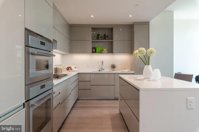 a kitchen with cabinets and white stainless steel appliances