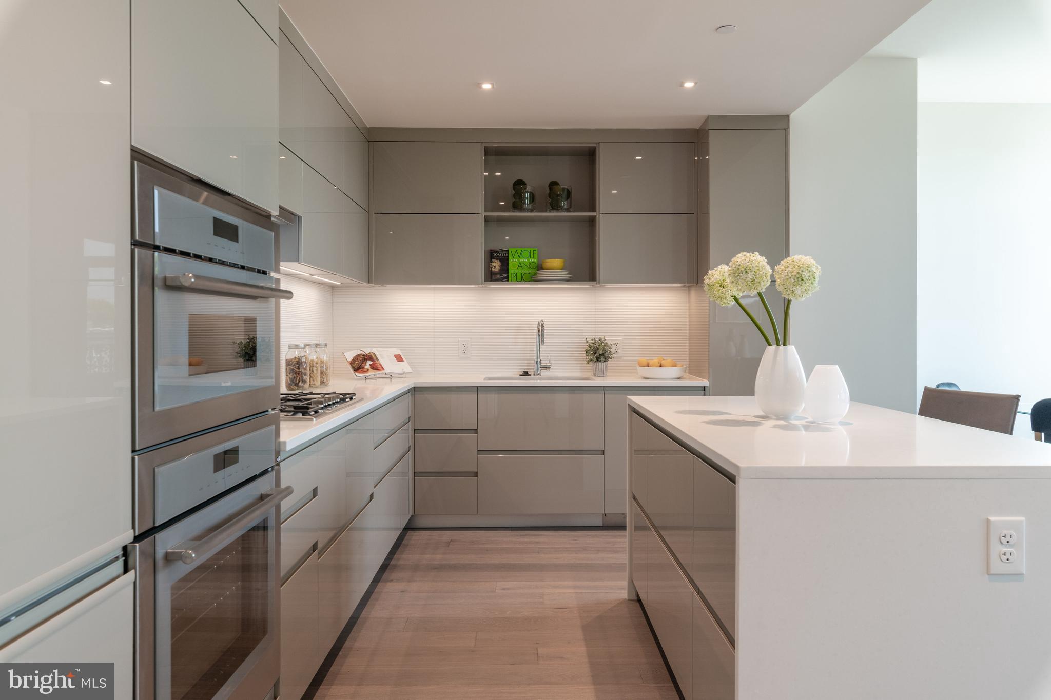 810 O Street Northwest, Unit 706 Washington, DC 20001 - Photo 23 of 48 a kitchen with cabinets and white stainless steel appliances