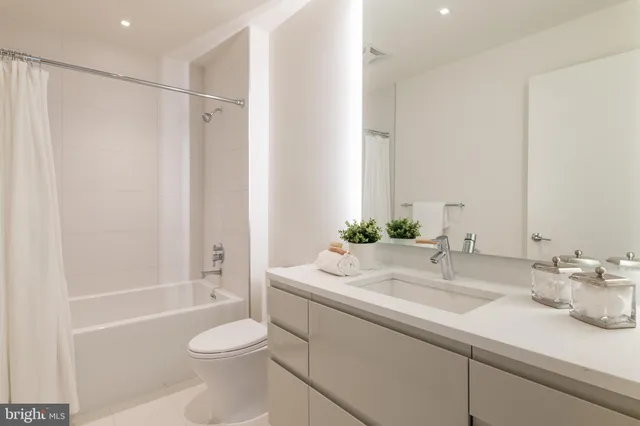 a bathroom with a sink toilet tub and shower