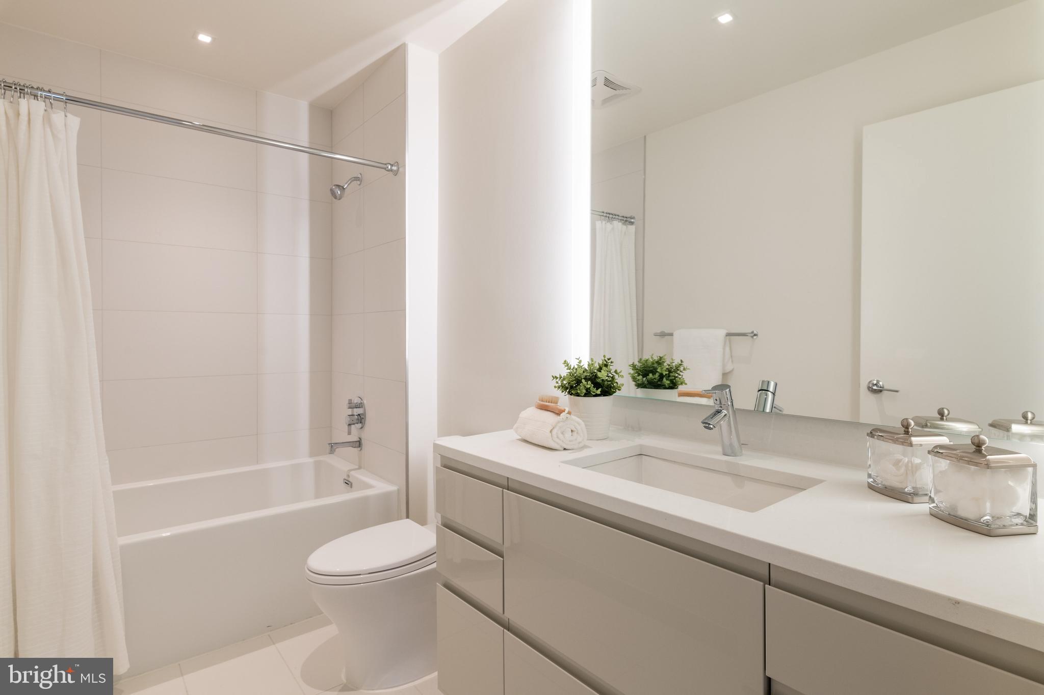 810 O Street Northwest, Unit 706 Washington, DC 20001 - Photo 25 of 48 a bathroom with a sink toilet tub and shower