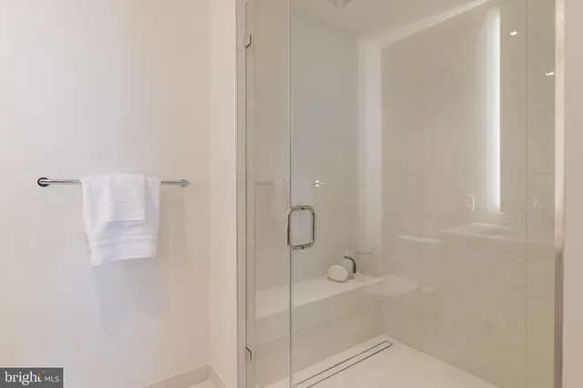 a bathroom with a glass shower door