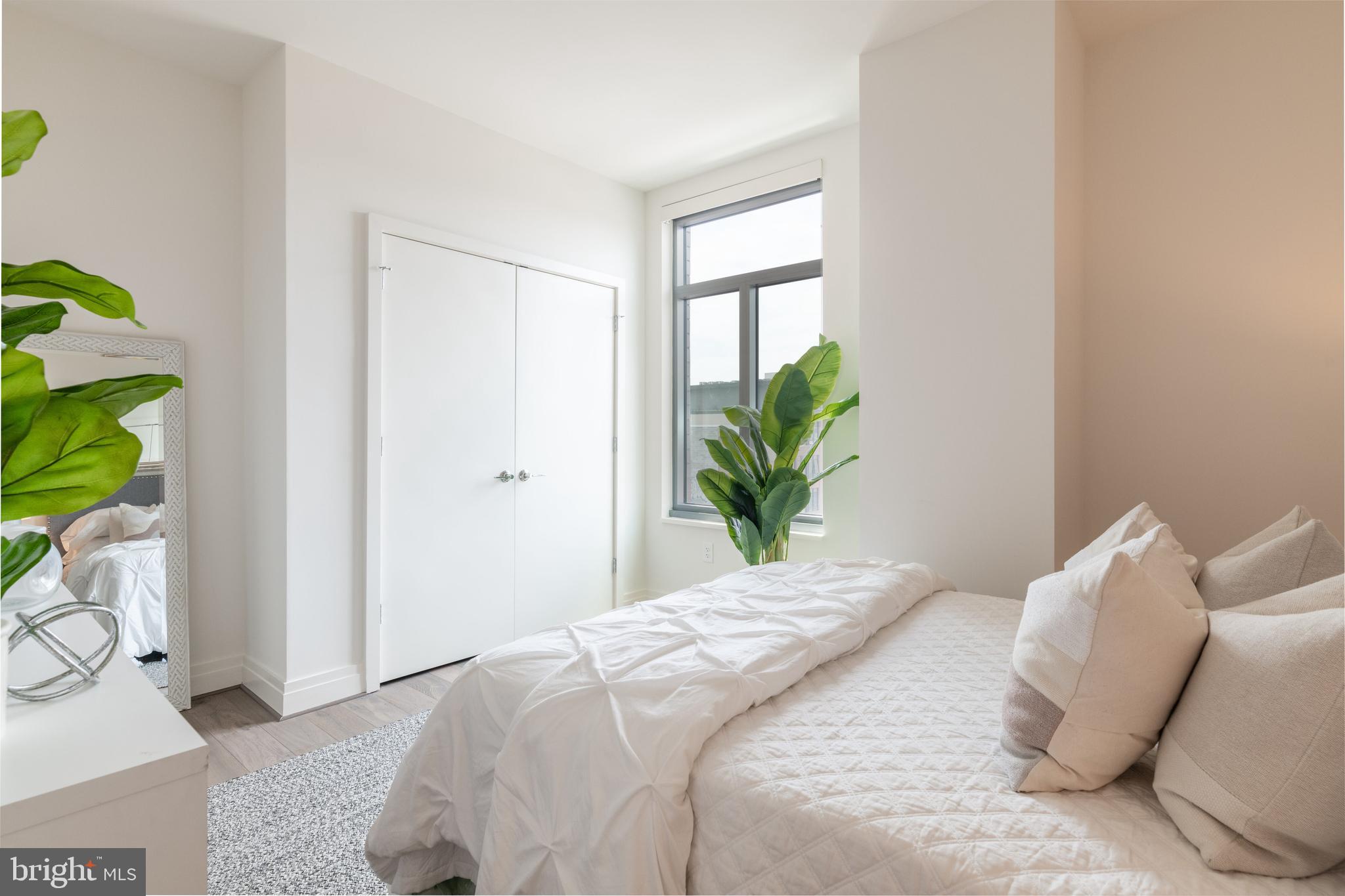 810 O Street Northwest, Unit 706 Washington, DC 20001 - Photo 28 of 48 a bedroom with a bed and a potted plant