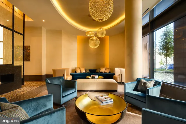 a dining room with furniture and a large window